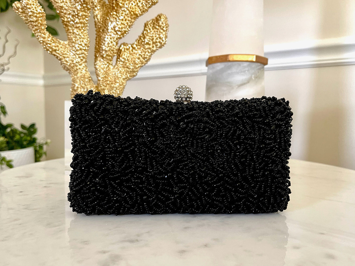 Black Beaded Embroidered Clutch Purse on a marble background, front view showcasing intricate beaded design