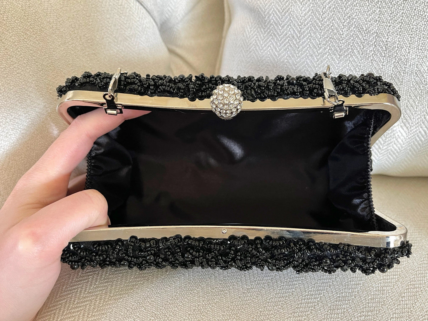 Inside of the Black Beaded Embroidered Clutch Purse against a neutral background, showcasing the spacious interior and lining