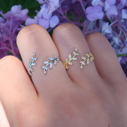 Model showcasing Cubic Zirconia Olive Leaf Adjustable Ring on hand with purple flower background