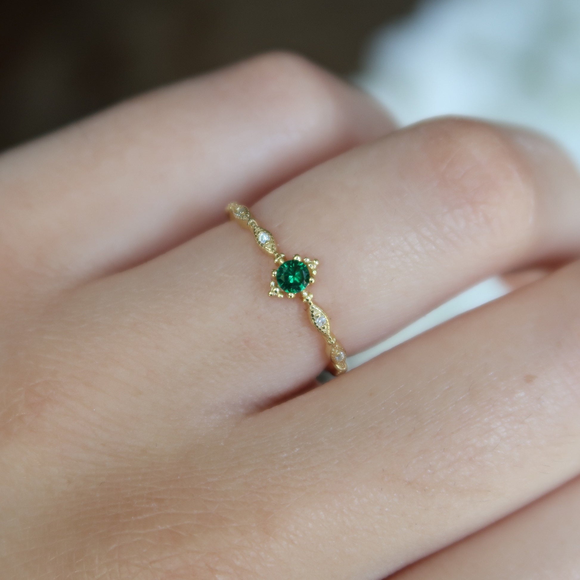 Model wearing Faux Emerald Dainty Ring on a hand, highlighting its minimalist style and vibrant faux emerald stone