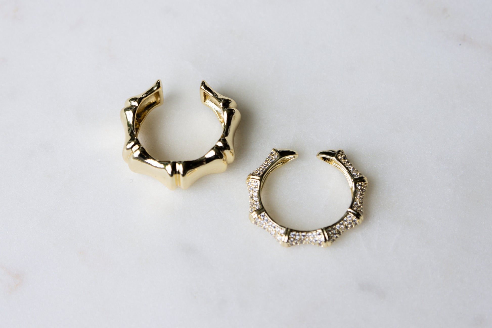 Both thin pave ring and thick bamboo ring modeled flat against a white background, demonstrating their complementary designs.