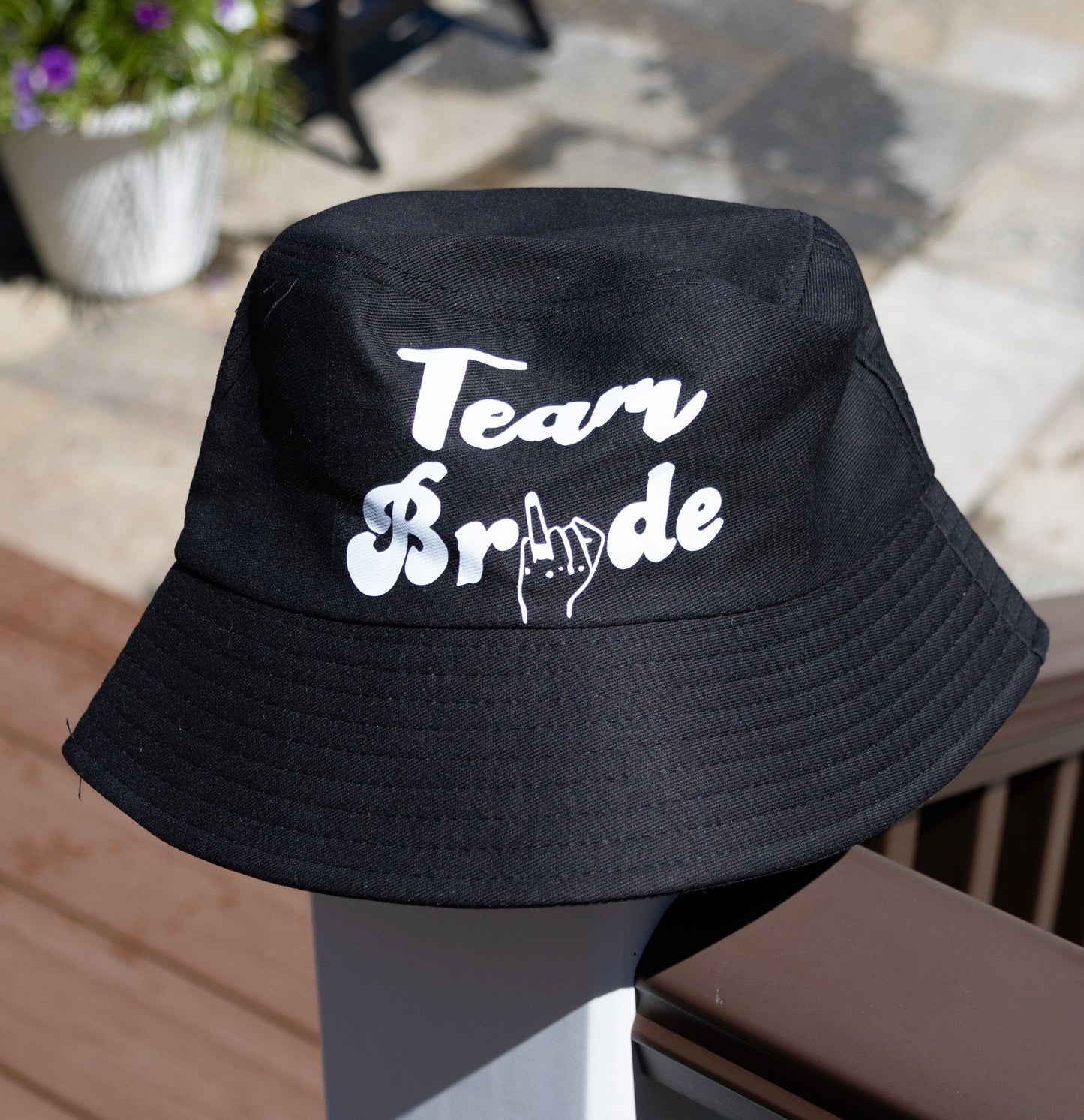 Team Bride Bucket Hat front view design modeled against a brown background