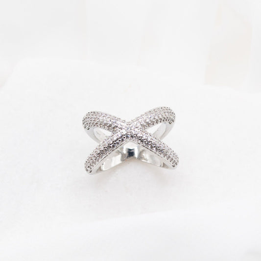 Top-down view of the Crossover Ring on a white background, emphasizing its minimalist style and quality craftsmanship.