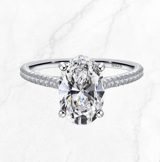 Front view of a 3CT moissanite engagement ring with a sleek 3mm band, set against a marble background, available in 18K gold-plated or S925 sterling silver.